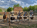 Riders posing for a picture at the coral before embarking on a sunset horseback ride.
