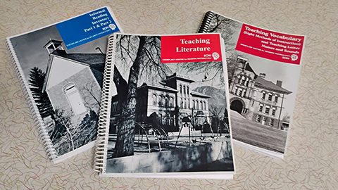 Three more teacher textbooks sitting on a table.